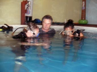Carol and Erin trying SCUBA under the instruction of Joe.  